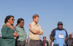 Prince Harry and officials receive a briefing in a minefield in Angola