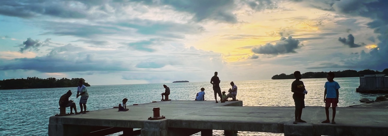 Locals relax on Munda pier in the evening 