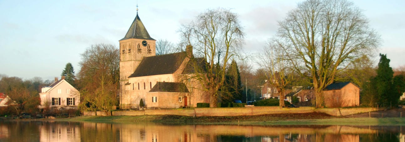 Old church of Oosterbeek, a Battle of Arnhem monument, reflected in the River Rhine