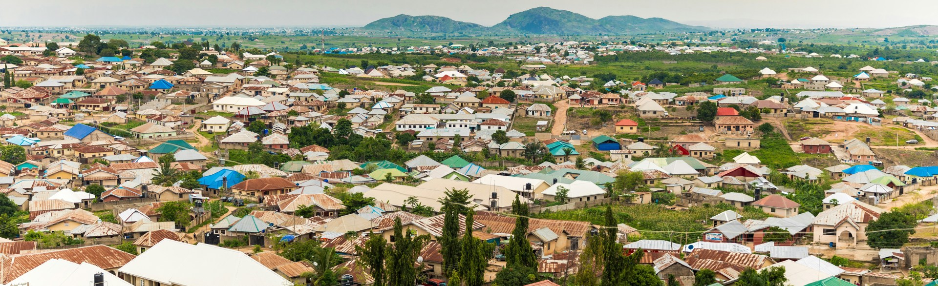 Nigerian homes with plains and hills behind