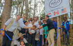 Jeroen Roodenburg and people from the Kwet Wala Indigenous Reserve cut a ribbon in celebration of its handover