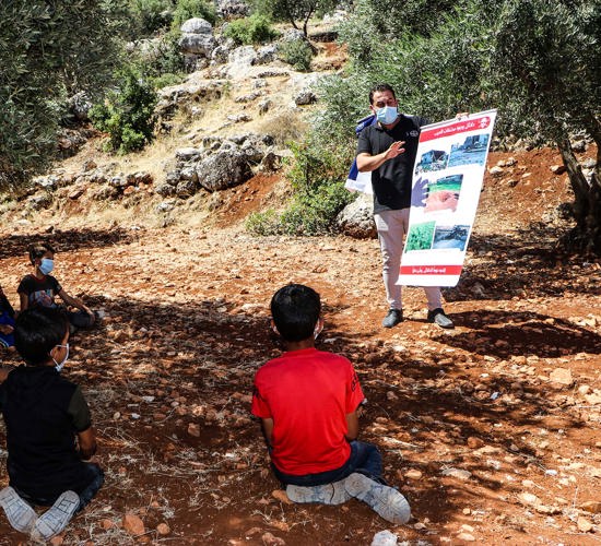 Children receiving an explosive ordnance risk education session in Syria