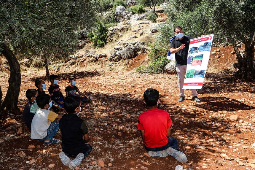 Children receiving an explosive ordnance risk education session in Syria