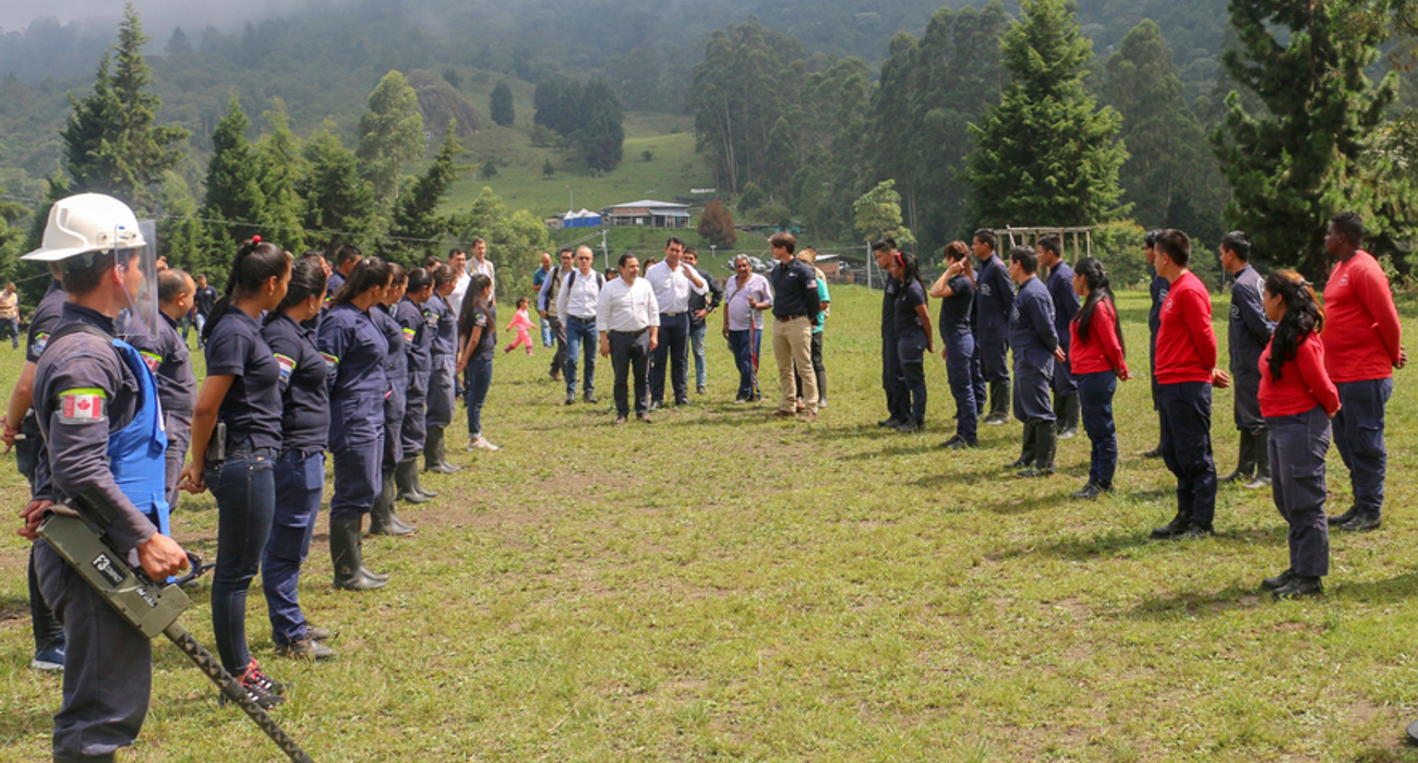 Cambodian deminers stand in line outside to welcome governments from the Netherlands, Canada and the United States