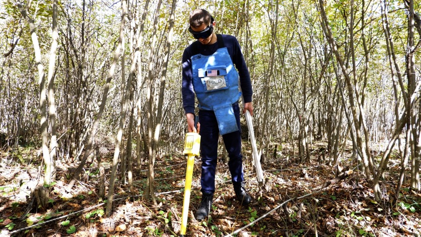 Shkëlzen, a HALO team supervisor scans for explosives in Kosovo