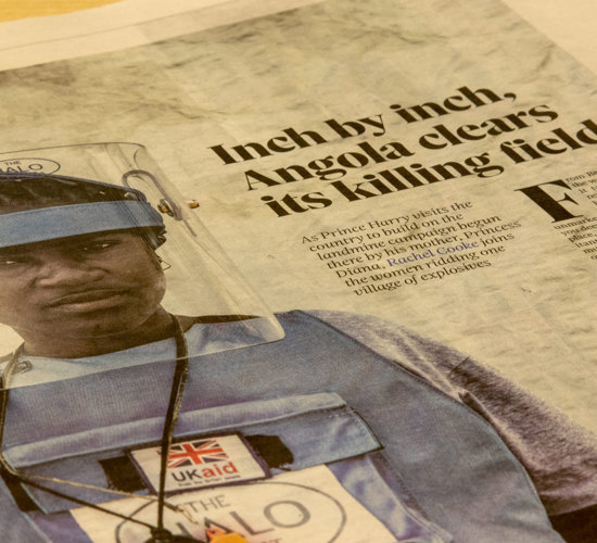 A newspaper with a photo of a HALO Trust deminer in Angola, along with a story about Prince Harry's visit to the country