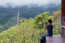 A young boy photographing the scenery, as taken by a classmate